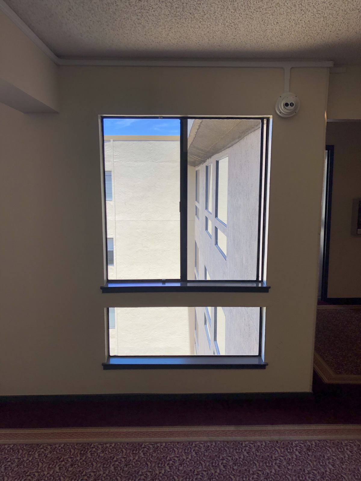 Security camera mounted beside an interior window