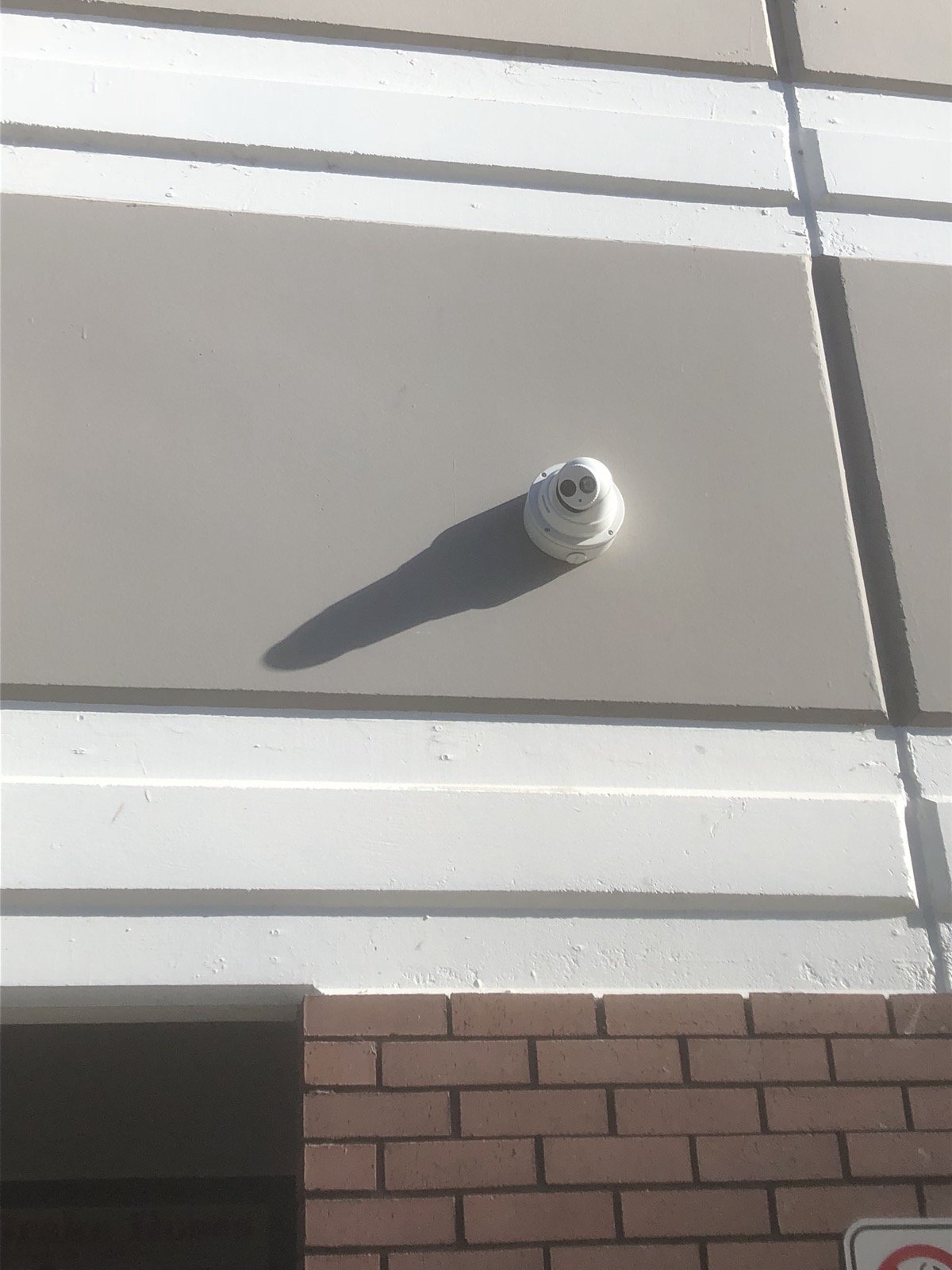 Security camera and conduit installed on a building exterior